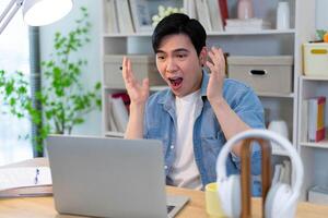 Young Asian businessman working at home photo