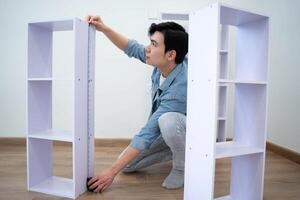 Asian man measuring and repairing houses photo