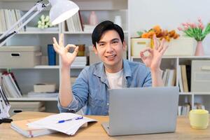 Young Asian businessman working at home photo