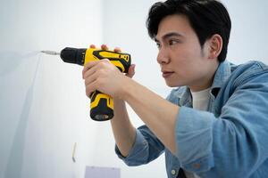 Asian man measuring and repairing houses photo