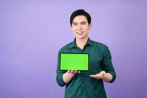 Young Asian business man holding tablet on background photo