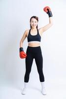 Young Asian woman wearing sportswear on white background photo