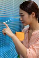 Young Asian woman at home office photo