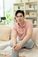 Photo of young Asian man at home