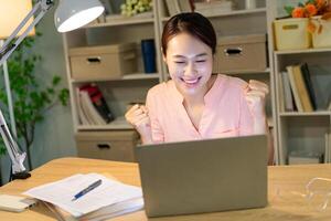 Young Asian woman working at night photo