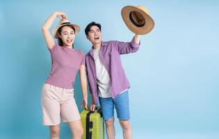 Young Asian couple on blue background photo