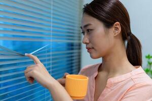 Young Asian woman at home office photo