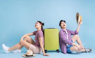 Young Asian couple on blue background photo