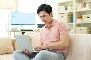 Photo of young Asian man at home