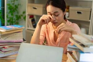 Young Asian woman working at night photo