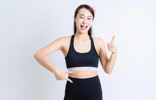 Young Asian woman wearing sportswear on white background photo