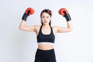 Young Asian woman wearing sportswear on white background photo