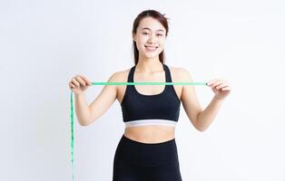 Young Asian woman wearing sportswear on white background photo