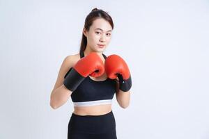 Young Asian woman wearing sportswear on white background photo