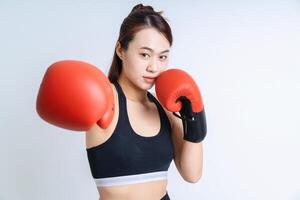 Young Asian woman wearing sportswear on white background photo