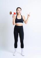 Young Asian woman wearing sportswear on white background photo