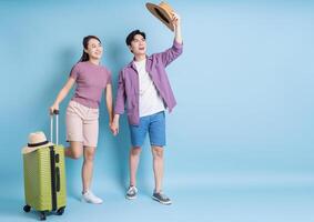 Young Asian couple on blue background photo