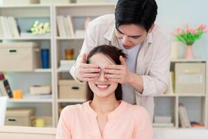 Photo of young Asian couple at home