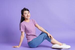 Photo of young Asian girl on purple background