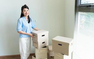 Young Asian woman moving to new house photo