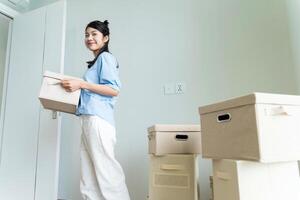 Young Asian woman moving to new house photo