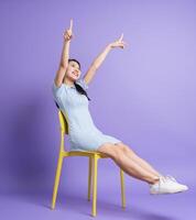 Photo of young Asian girl on purple background