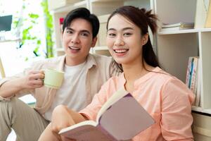 Photo of young Asian couple at home