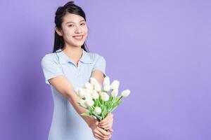 Photo of young Asian girl on purple background