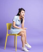 Photo of young Asian girl on purple background