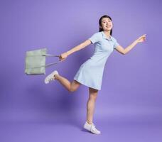 Photo of young Asian girl on purple background