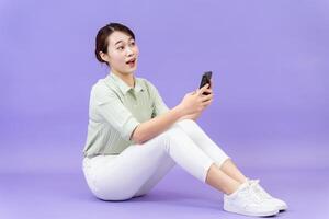 Photo of young Asian woman on purple background