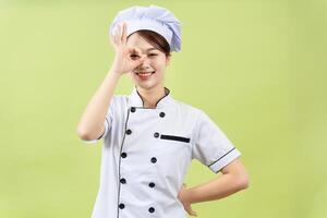 Photo of young Asian female chef on background