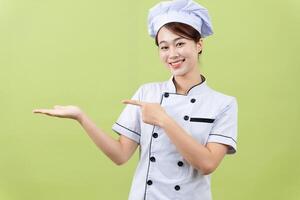 Photo of young Asian female chef on background