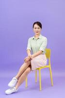 Photo of young Asian woman on purple background