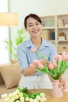 Photo of young Asian woman at home