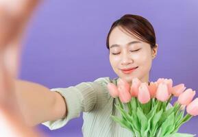 Photo of young Asian woman on purple background