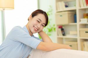 Photo of young Asian woman at home