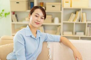 Photo of young Asian woman at home