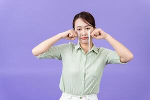 Photo of young Asian woman on purple background