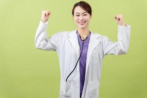 Photo of young Asian femle doctor on green background