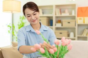 Photo of young Asian woman at home