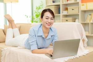 Photo of young Asian woman at home