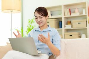 Photo of young Asian woman at home