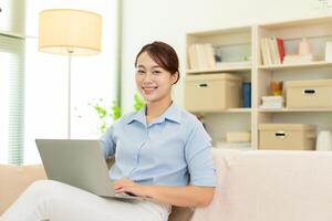 Photo of young Asian woman at home