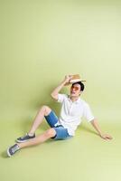 Photo of young Asian man on green background