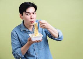 Photo of young Asian man on green background