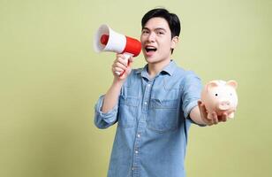 Photo of young Asian man on green background