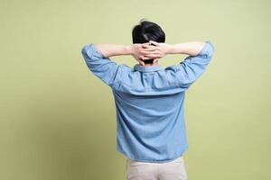 Photo of young Asian man on green background