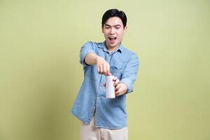 Photo of young Asian man on green background