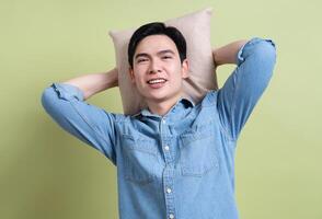 Photo of young Asian man on green background